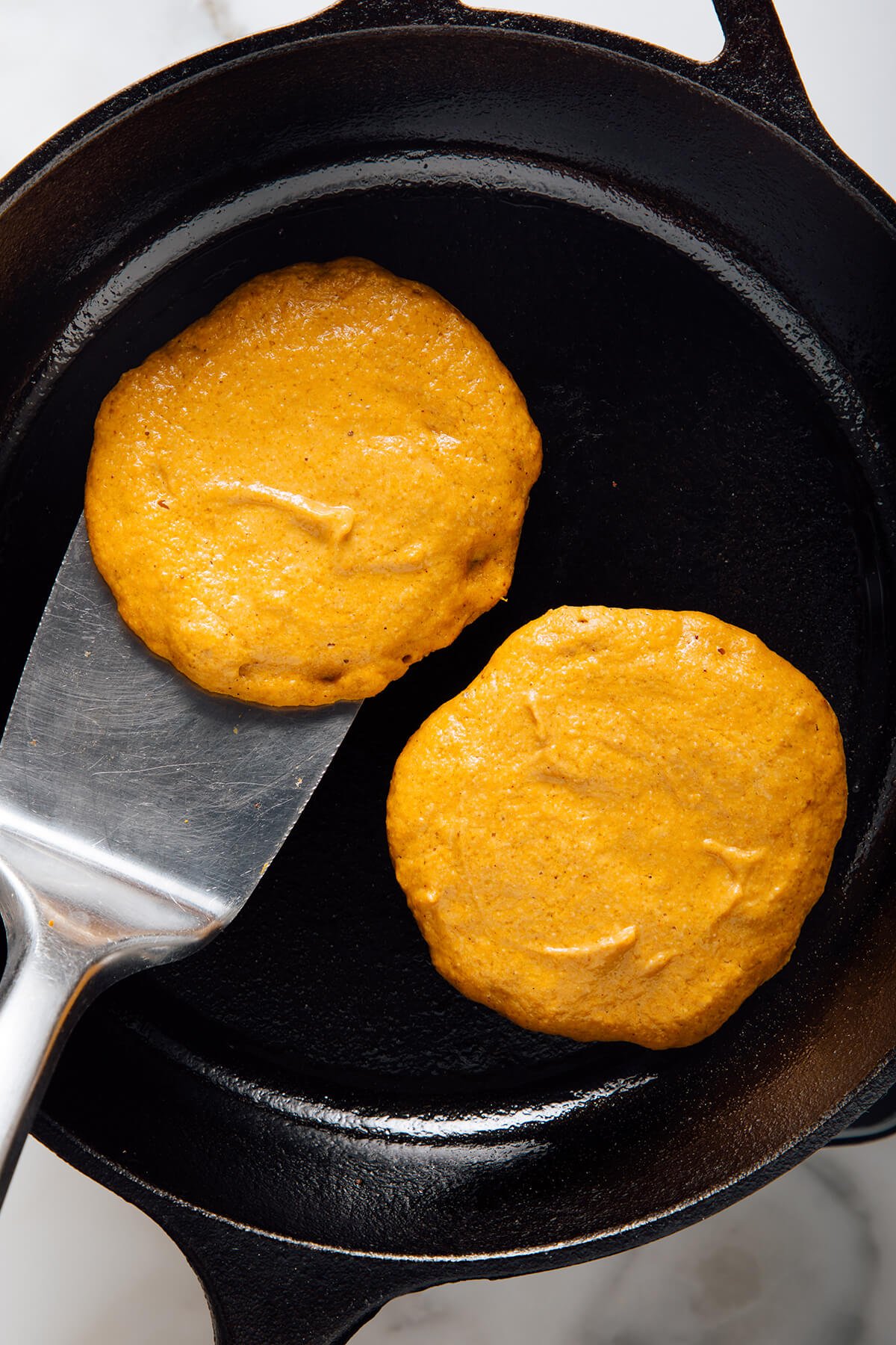 pumpkin oat pancakes before flipping