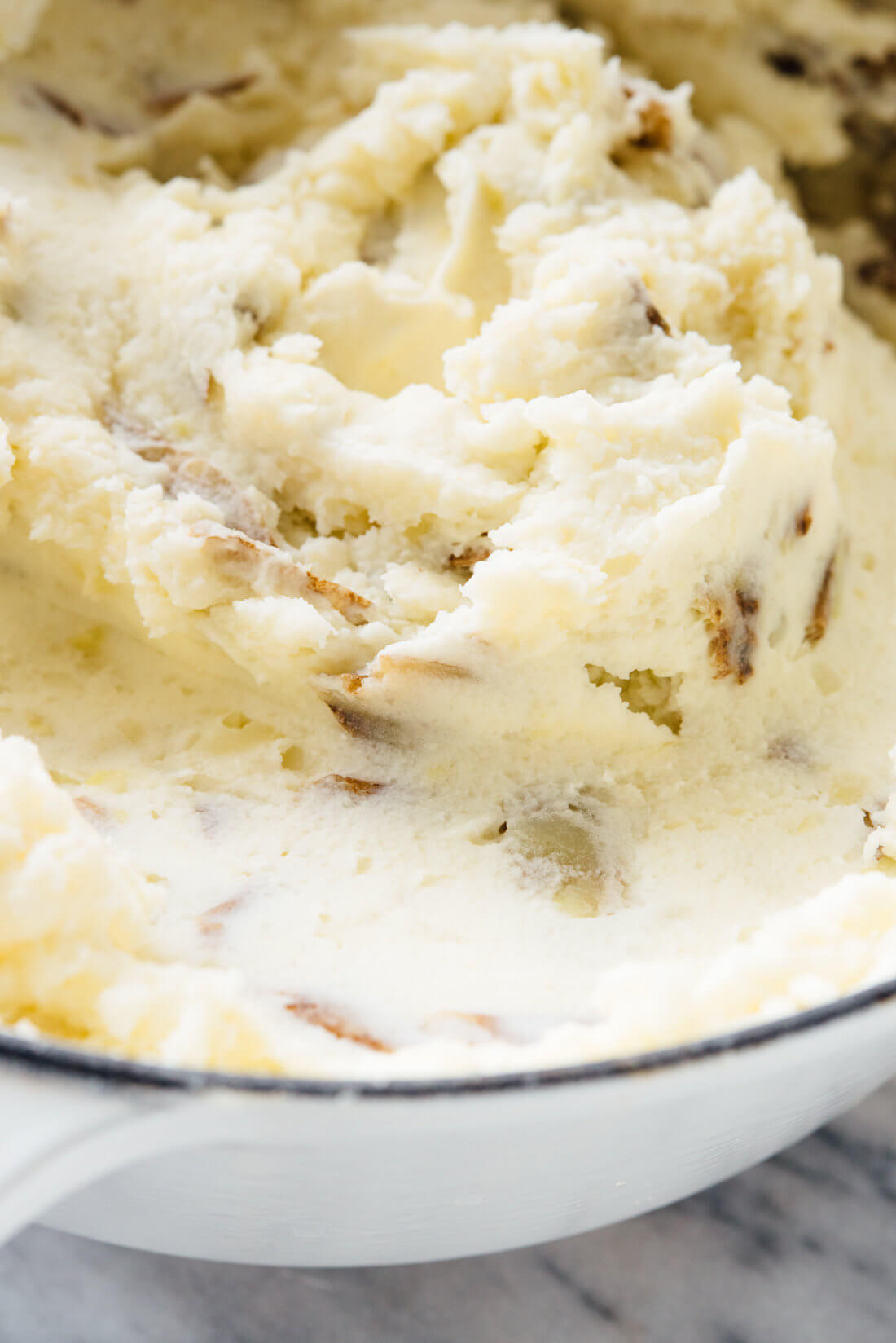 My family's favorite mashed potatoes—they're ultra creamy, a little tangy, and you can make them ahead! #Thanksgiving