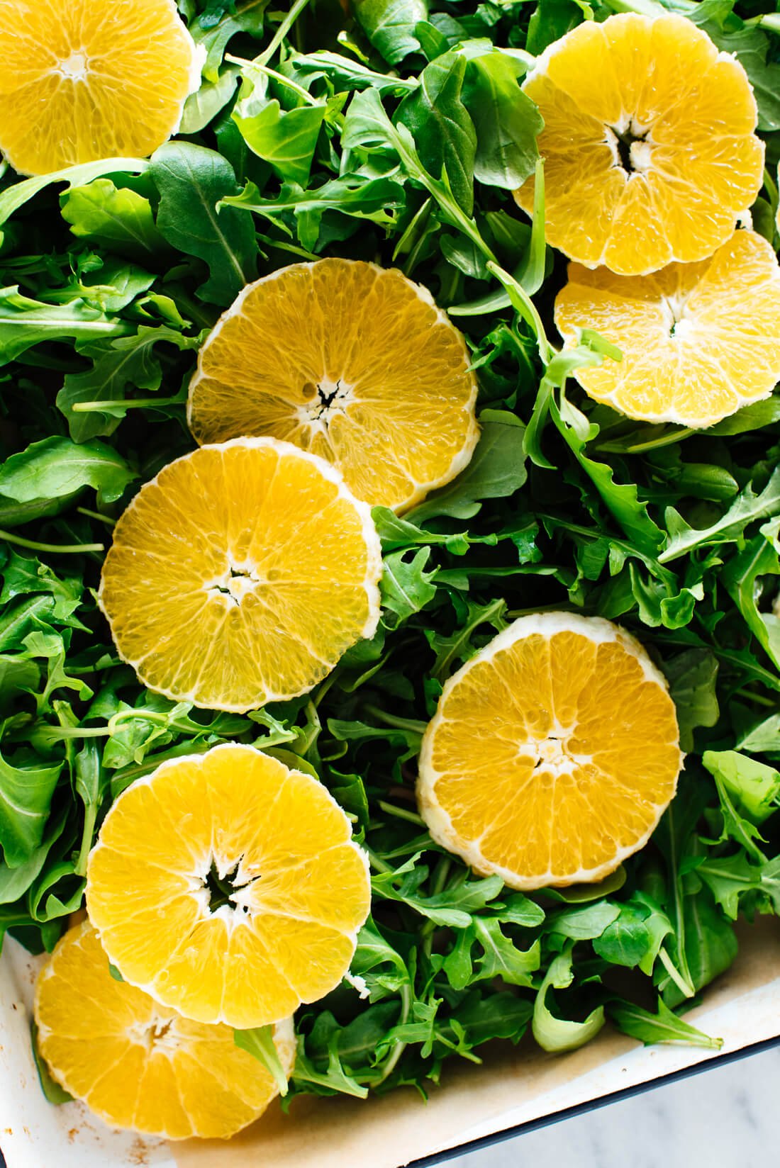 sliced orange on arugula
