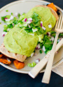 Sweet potato burrito smothered with avocado salsa verde