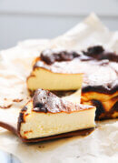 slice of Basque cheesecake next to cheesecake