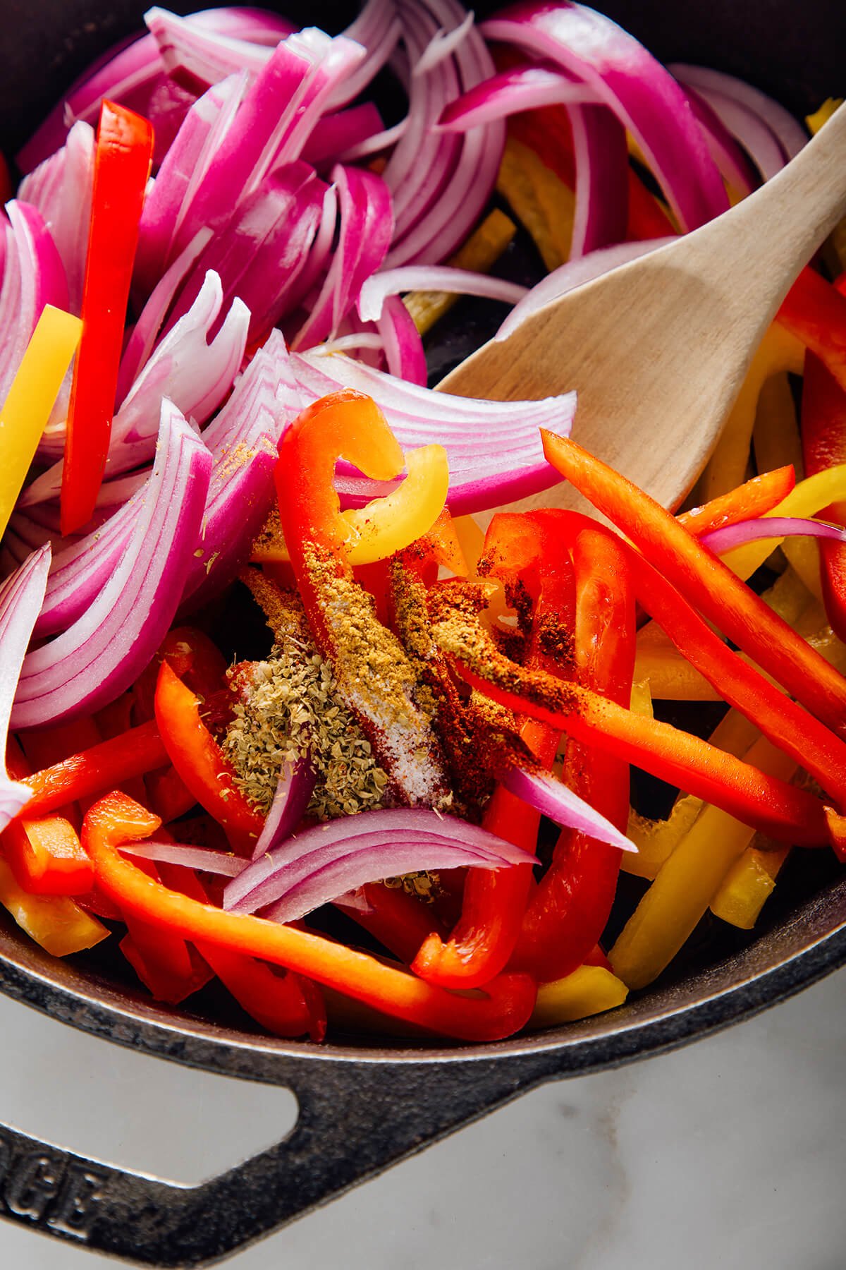 adding spices to vegetables